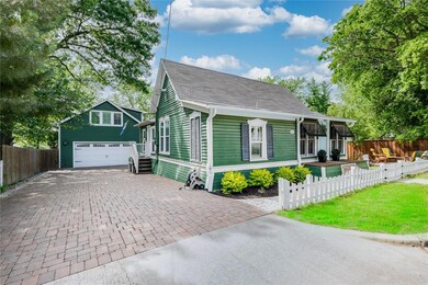 A large driveway and detached garage on the side o