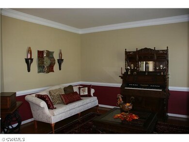 Living Room - Much quality crown molding and chair rail in this spacious living room.