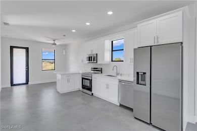 Kitchen featuring white cabinets, a healthy amount