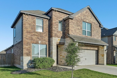 View of front of house featuring brick siding, a garage, a shingled roof, and concrete driveway