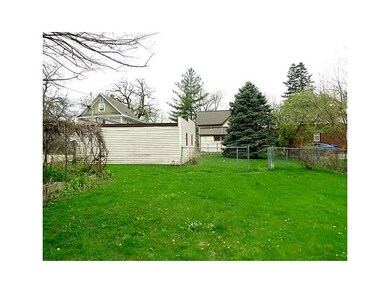 Exterior Back. Pretty good sized lot with fencing