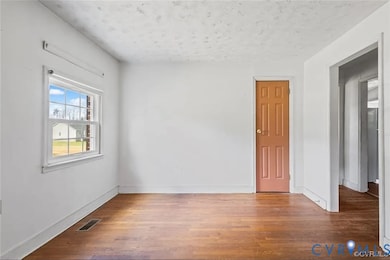 Dining room with light wood-style floors and a textured ceiling