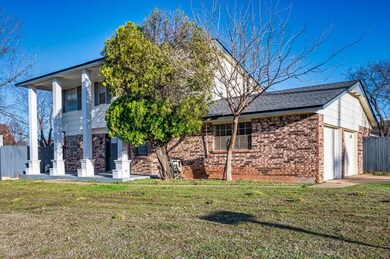 View of front of home featuring brick siding, a ga