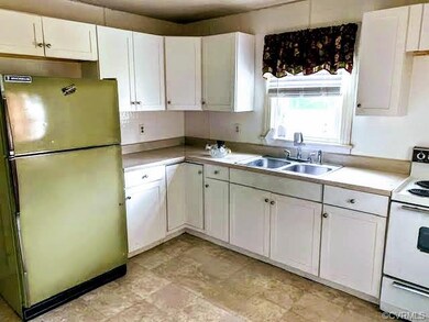 kitchen: newer cabinetry, retro refrigerator, window overlooking backyard