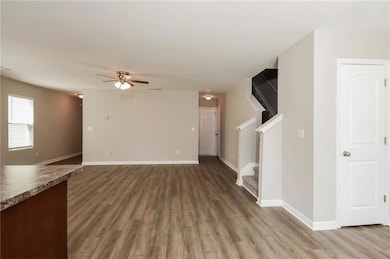 Unfurnished living room with baseboards, a ceiling