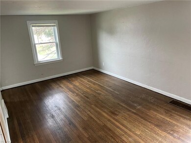 Unfurnished room with dark hardwood flooring