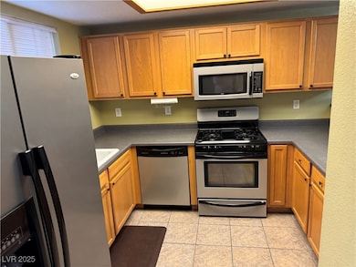Kitchen featuring light tile patterned floors, a s