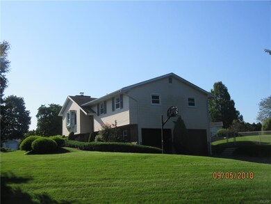 Side view shows the updated garage doors and new d