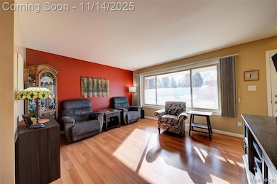 Living area with light wood-style floors and baseboards