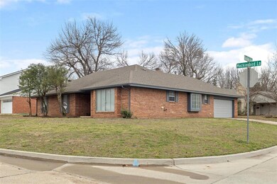 Ranch-style house with brick siding, roof with shi