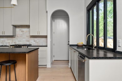 Kitchen featuring stainless steel appliances, lig