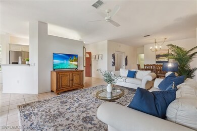 Living room with light tile patterned floors, ceil