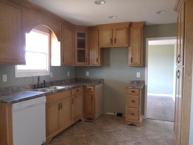 Lovely kitchen with custom cabinets, appliances to be installed, and a pantry.