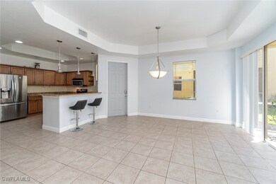 Kitchen with visible vents, a raised ceiling, appl