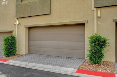 Garage featuring decorative driveway