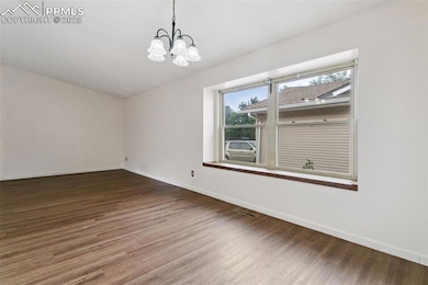 The dining room is awash in natural light from the large window.