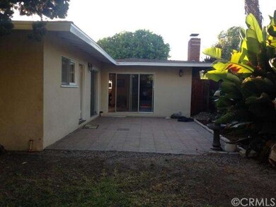 Back of House with patio leading to large backyard