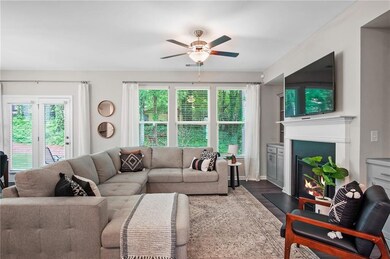 Living room featuring ceiling fan and dark hardwoo