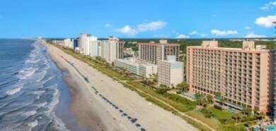 Aerial view featuring a water view and a beach vie