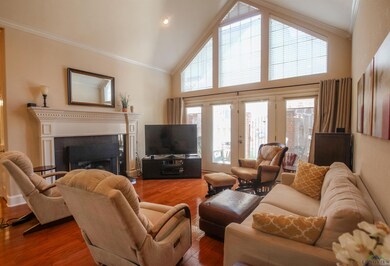 Living room featuring high vaulted ceiling, crown 