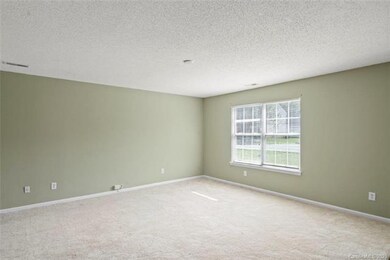 LIVING ROOM: This home features neutral earth-tone
