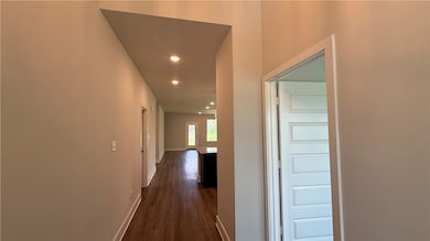 Hallway featuring recessed lighting and dark wood-
