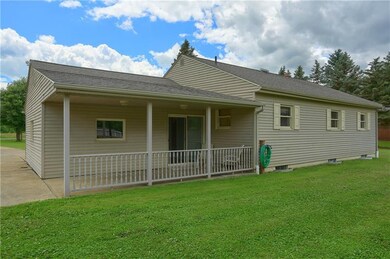 Back view of house covered porch and breeze way en