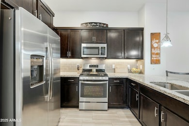 Dark cabinets, granite, SS appliances