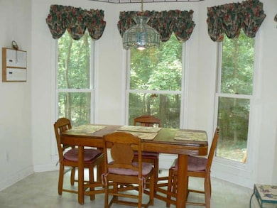 BREAKFAST AREA OVERLOOKS PRIVATE TREEDED BACK LAWN