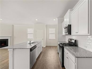 Kitchen with a kitchen island with sink, light sto