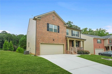 View of front of house featuring a porch, a front yard, driveway, a garage, and brick siding