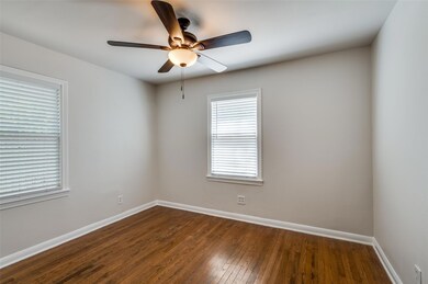 Spare room with ceiling fan and dark hardwood / wo