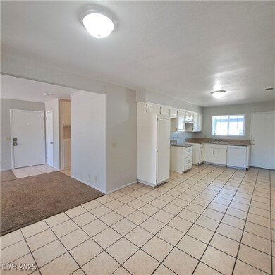 Kitchen with light countertops, open floor plan, w