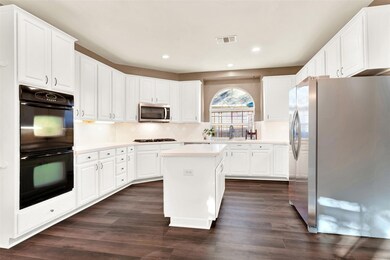 This kitchen is great. It has a lot of space for growing herbs and plants, a great view, and lots of natural light.
