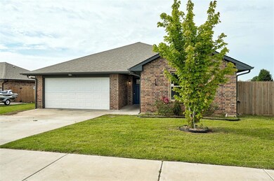 View of front of house featuring a garage, driveway, brick siding, and a shingled roof
