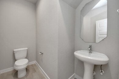 Step into this bright and airy half bath convenien