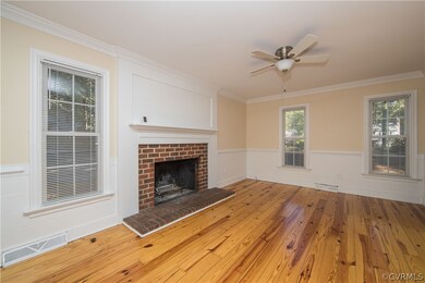 living room with wood floors, overhead fan, firepl