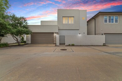 A rear entry gate and alley-access garage provide