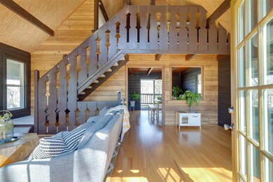Open living space with vaulted ceiling welcomes yo