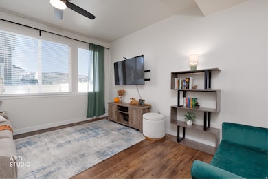 Living room with large window and ceiling fan