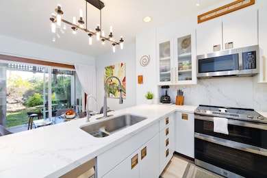 Completely remodeled Kitchen, quartz countertops, stainless appliances. Thomasville Cabinets with full overlay doors, dovetail joints, and soft close doors, Glass Front Upper Cabinet doors, ThinQ refrigerator