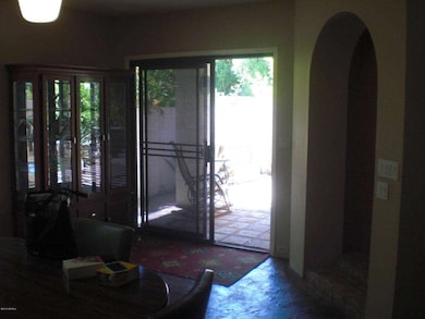 Archway to kitchen/sliding door to yard