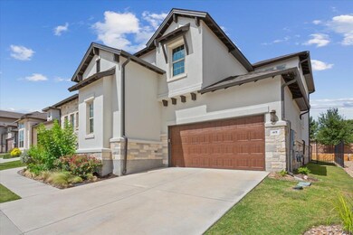 View of front of house with stone siding, stucco 