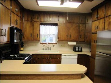 Kitchen offers large eating bar, pantry and lots o