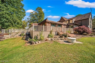 Rear view of property featuring a deck and brick siding