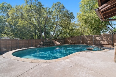 Enjoy this beautiful pool with slide water feature and in pool seating with table!