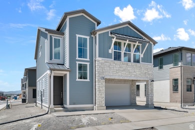 View of front of home featuring stone siding, an attached garage, driveway, and board and batten siding