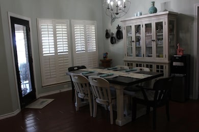 Dining area featuring a chandelier and dark wood 