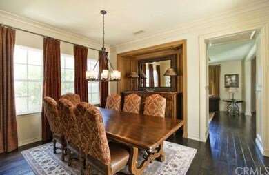 Gorgeous formal dining room accented with rich dra