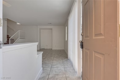 Hall with light marble finish flooring and stairs
